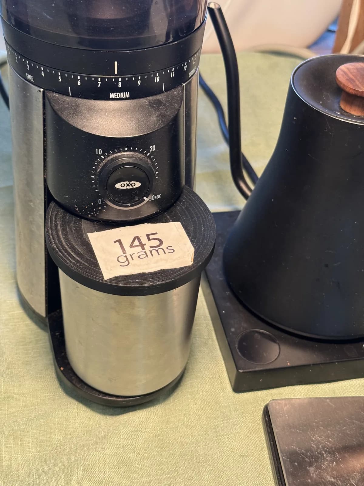 Coffee grinder marked with a 14.5 grams setting label