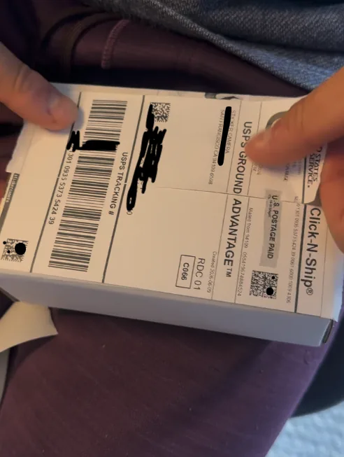 Custom shipping label being attached to a package
